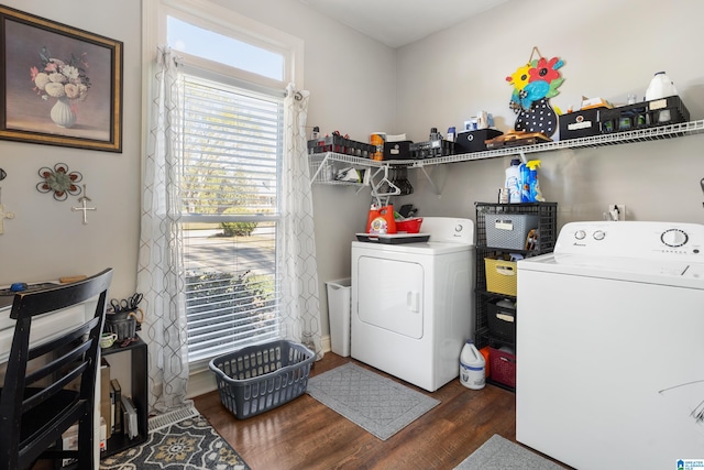 laundry area with washer and clothes dryer and dark wood-type flooring