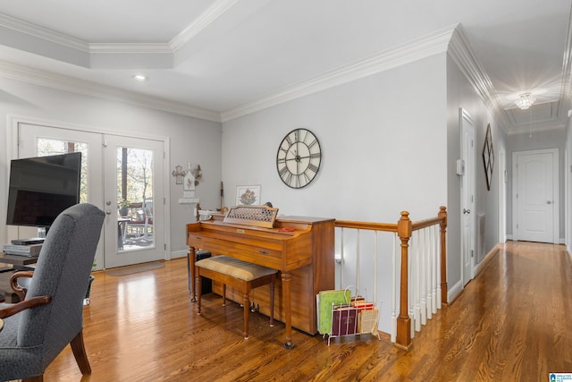 office area with a tray ceiling, hardwood / wood-style floors, and ornamental molding