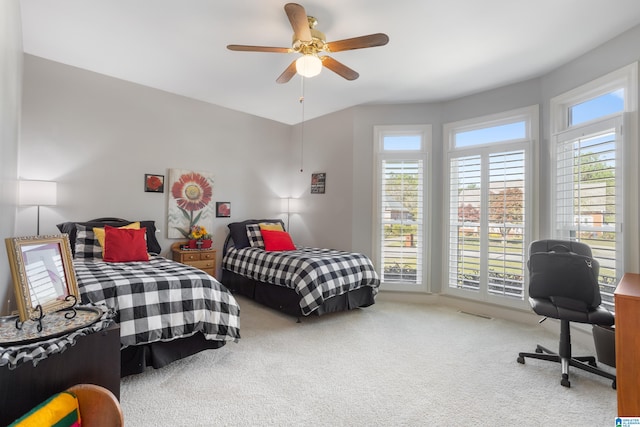 bedroom with carpet, multiple windows, and ceiling fan