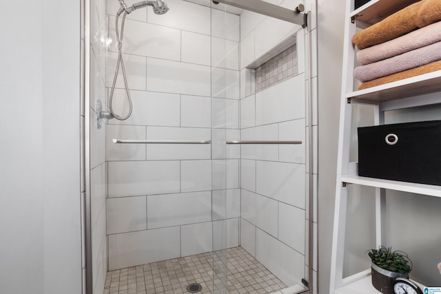 bathroom featuring a shower with door