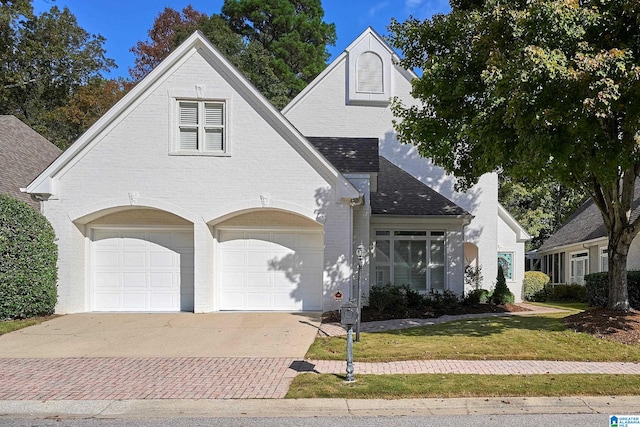 view of front of house featuring a garage and a front lawn