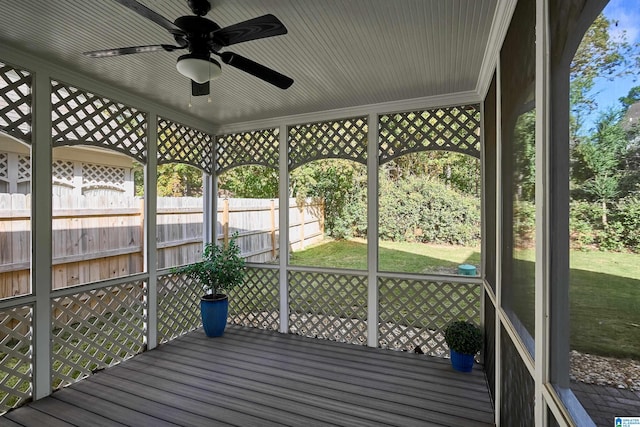 unfurnished sunroom with ceiling fan