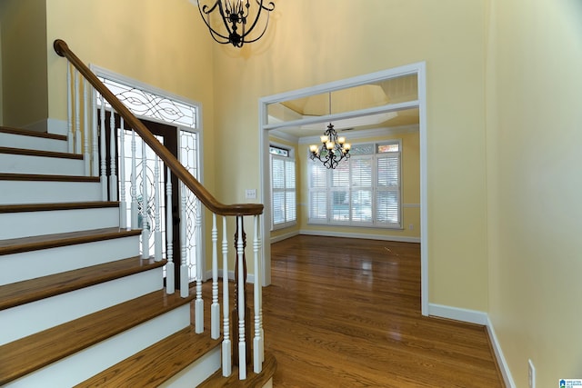 foyer featuring hardwood / wood-style flooring and an inviting chandelier