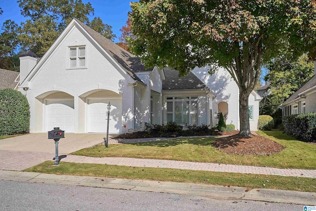 front facade featuring a front yard and a garage