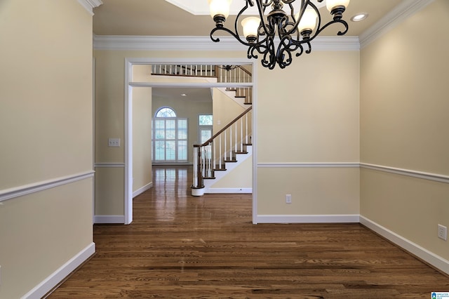 interior space with ornamental molding, dark wood-type flooring, and an inviting chandelier