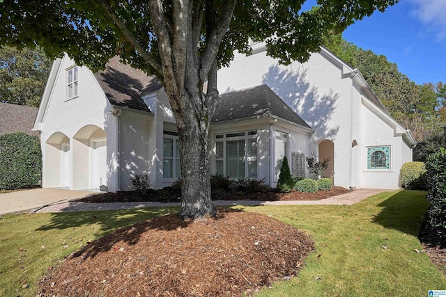 view of front of house with a front yard and a garage