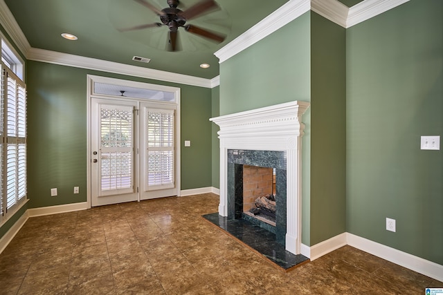 unfurnished living room featuring ceiling fan, crown molding, and a premium fireplace