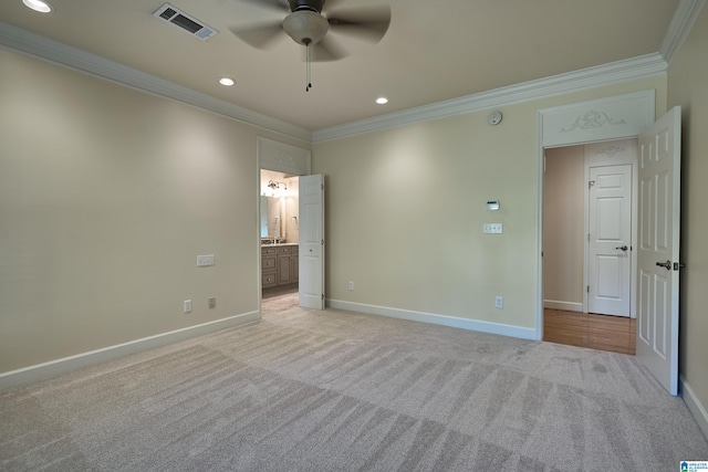 carpeted spare room featuring ceiling fan and ornamental molding