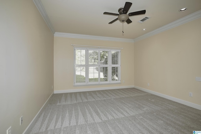 carpeted empty room featuring ceiling fan and crown molding