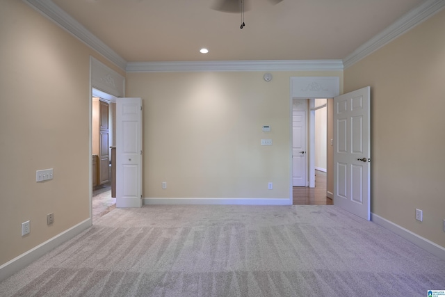 empty room with light carpet, ceiling fan, and ornamental molding