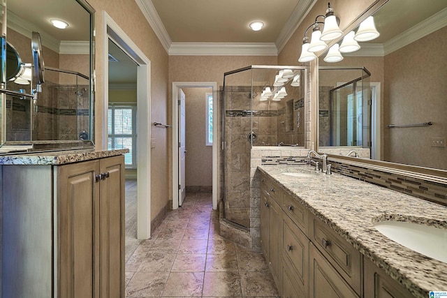 bathroom with a chandelier, vanity, a shower with shower door, and crown molding