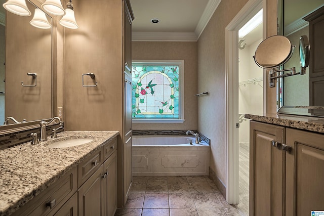 bathroom featuring vanity, crown molding, and tiled tub