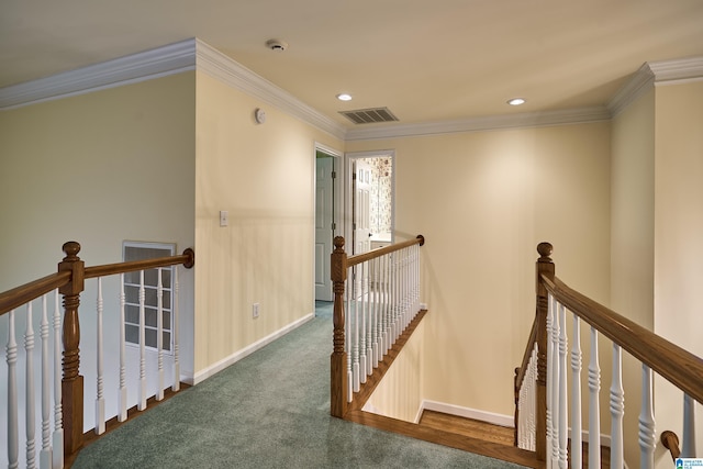 hallway with dark carpet and crown molding