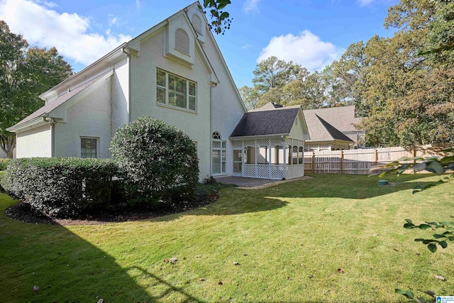 view of home's exterior with a yard