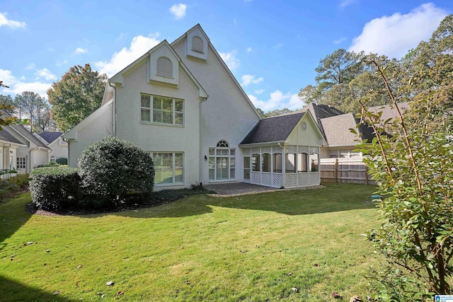 rear view of property with a lawn