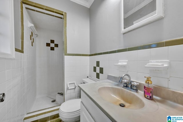 bathroom with toilet, tiled shower, vanity, tile walls, and ornamental molding