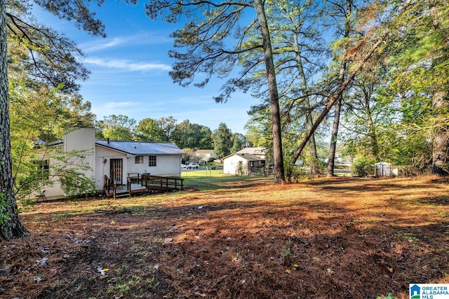 view of yard featuring a wooden deck