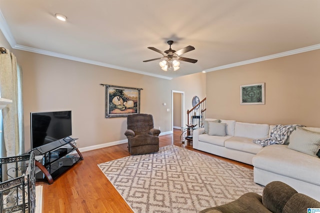 living room with ceiling fan, ornamental molding, and hardwood / wood-style floors