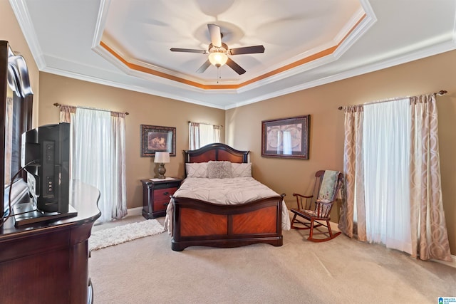 bedroom featuring crown molding, ceiling fan, a raised ceiling, and light colored carpet