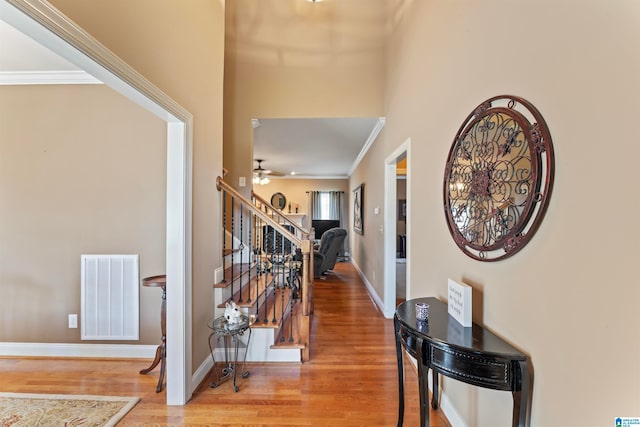 hall featuring wood-type flooring and ornamental molding