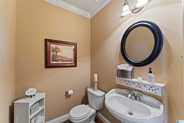 bathroom with crown molding, toilet, and sink