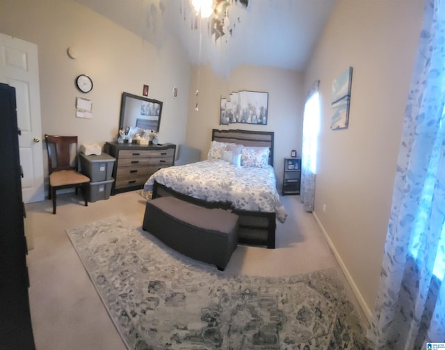 carpeted bedroom featuring lofted ceiling