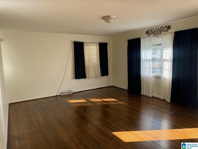 spare room with dark hardwood / wood-style floors