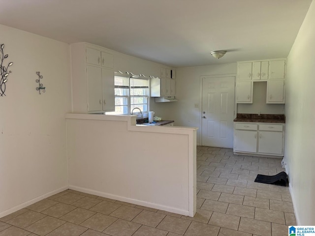 kitchen featuring white cabinetry and light tile patterned floors