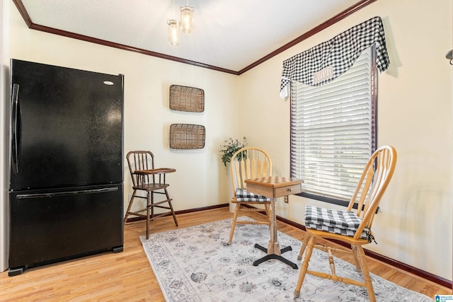 home office featuring light hardwood / wood-style flooring and ornamental molding