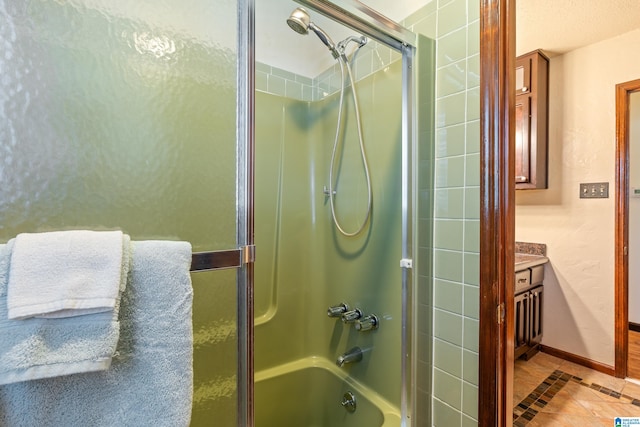 bathroom with tile patterned floors and shower / bath combination with glass door