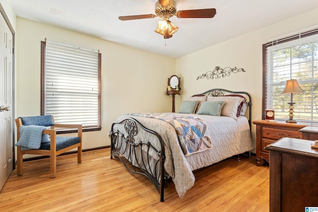 bedroom with light hardwood / wood-style floors and ceiling fan