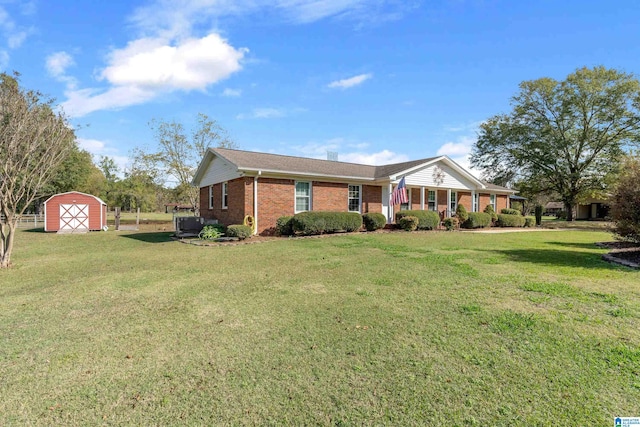 single story home with a front yard and a storage shed