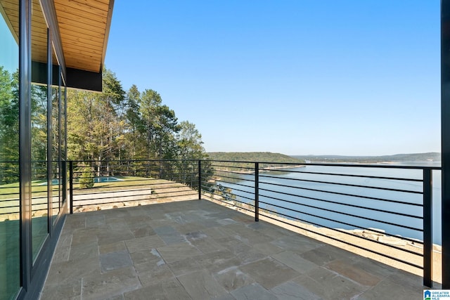 exterior space with a balcony and a water view