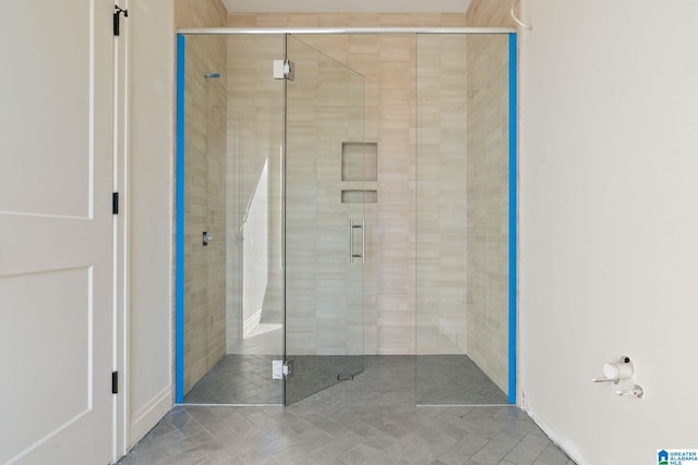 bathroom with a shower with shower door