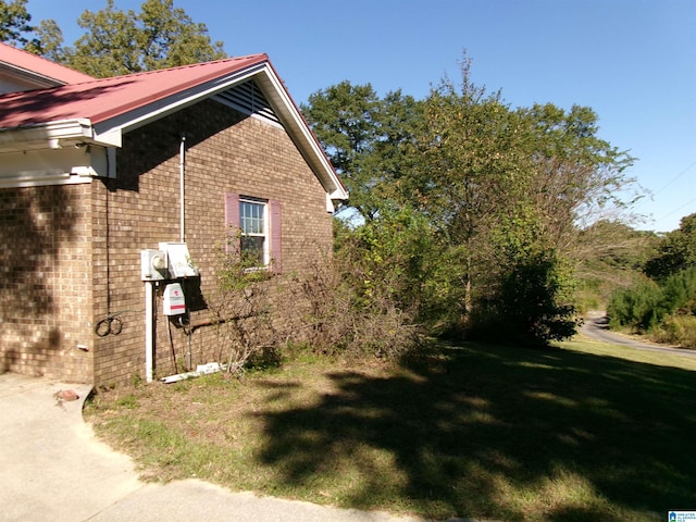 view of property exterior with a yard