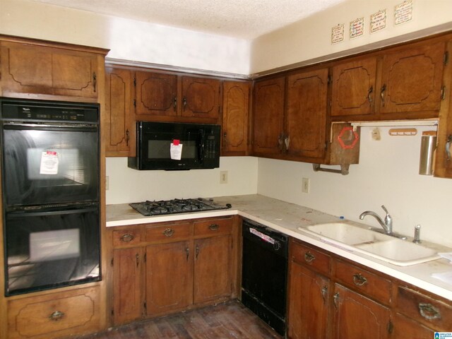 1663 County Road 2, Montevallo, AL 35115 - kitchen featuring black appliances, a sink, light countertops, brown cabinets, and a textured ceiling