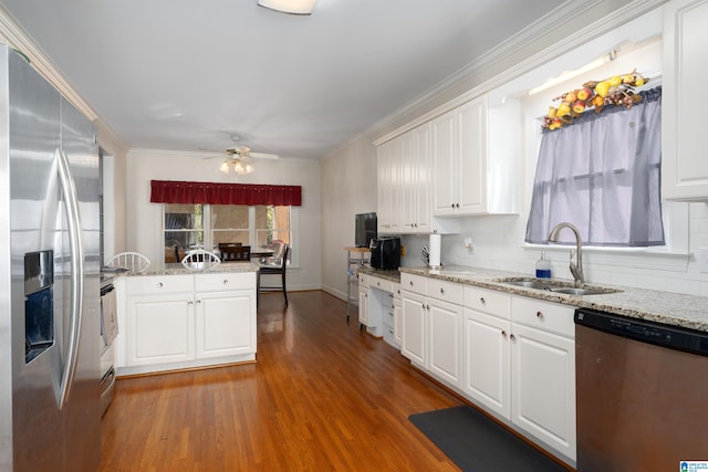 kitchen featuring white cabinetry, sink, dark wood-type flooring, appliances with stainless steel finishes, and ornamental molding