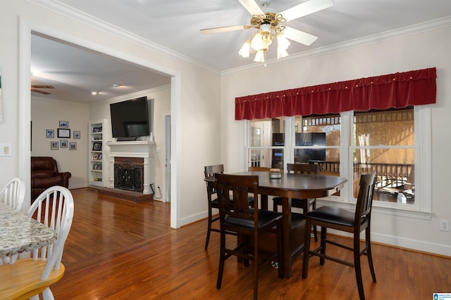 dining area with ceiling fan, crown molding, and wood-type flooring