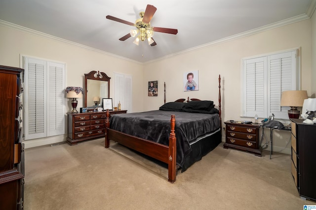 carpeted bedroom featuring ceiling fan and ornamental molding