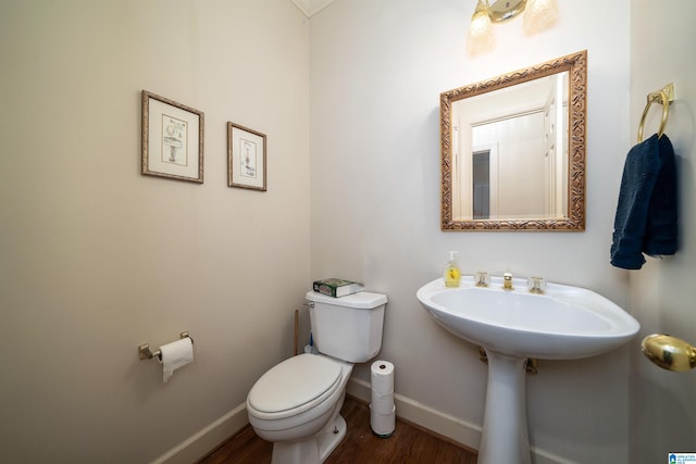 bathroom featuring hardwood / wood-style flooring and toilet