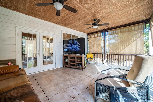 sunroom / solarium featuring french doors, ceiling fan, and wooden ceiling