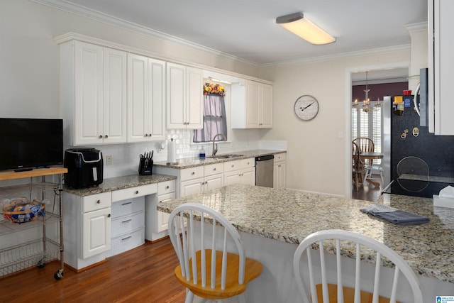 kitchen featuring dark hardwood / wood-style flooring, stainless steel dishwasher, sink, an inviting chandelier, and white cabinetry