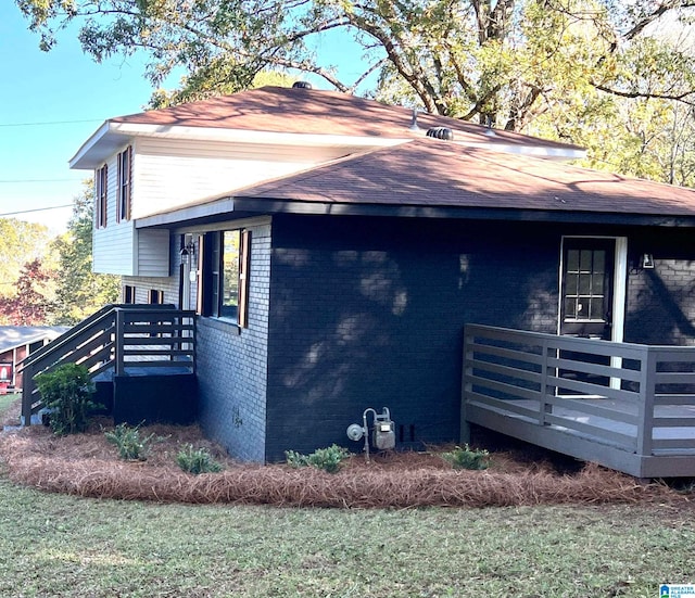 view of side of home with a wooden deck