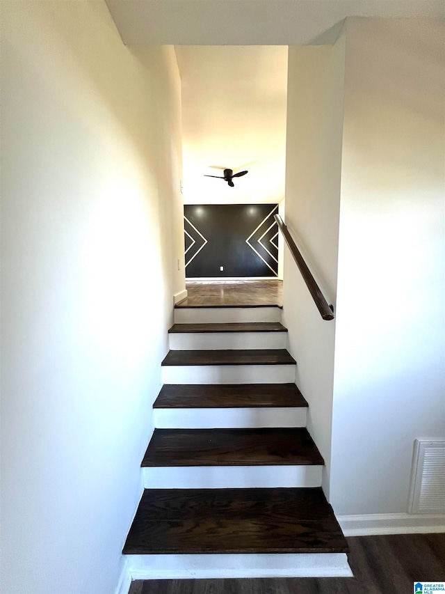 stairs with ceiling fan and hardwood / wood-style floors