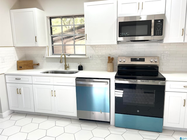 kitchen with white cabinetry, sink, appliances with stainless steel finishes, and tasteful backsplash