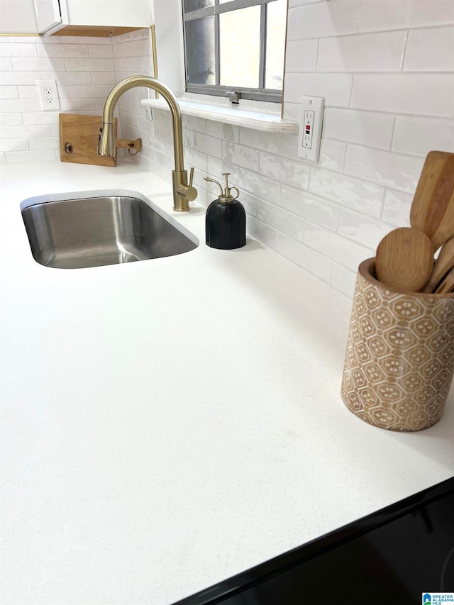 interior details featuring backsplash and sink