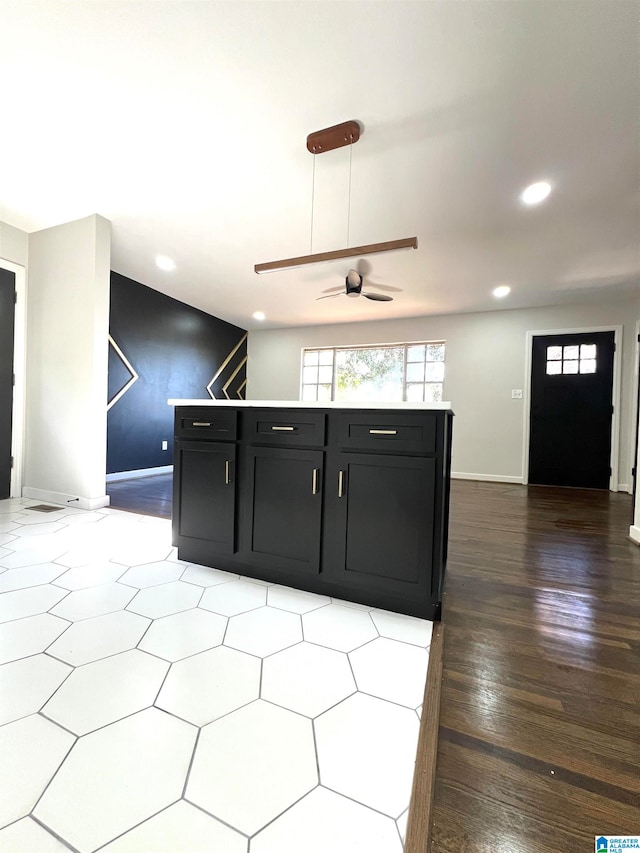 kitchen featuring ceiling fan and hardwood / wood-style flooring