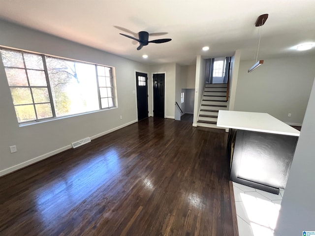 interior space with dark hardwood / wood-style flooring and ceiling fan