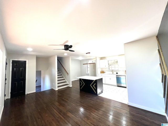 unfurnished living room with ceiling fan, dark hardwood / wood-style flooring, and sink