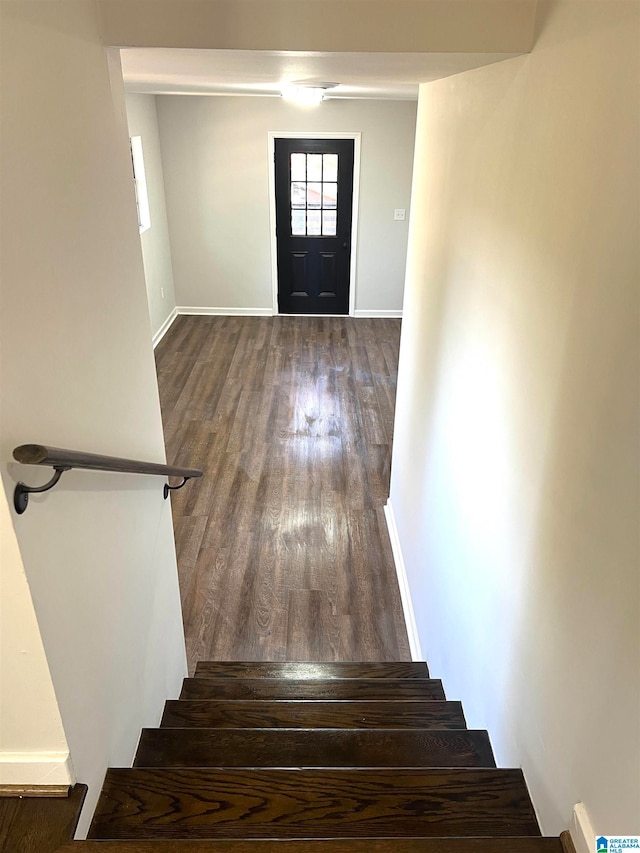 stairs featuring hardwood / wood-style floors